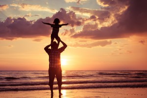 46432351 - father and son playing on the beach at the sunset time. concept of friendly family.